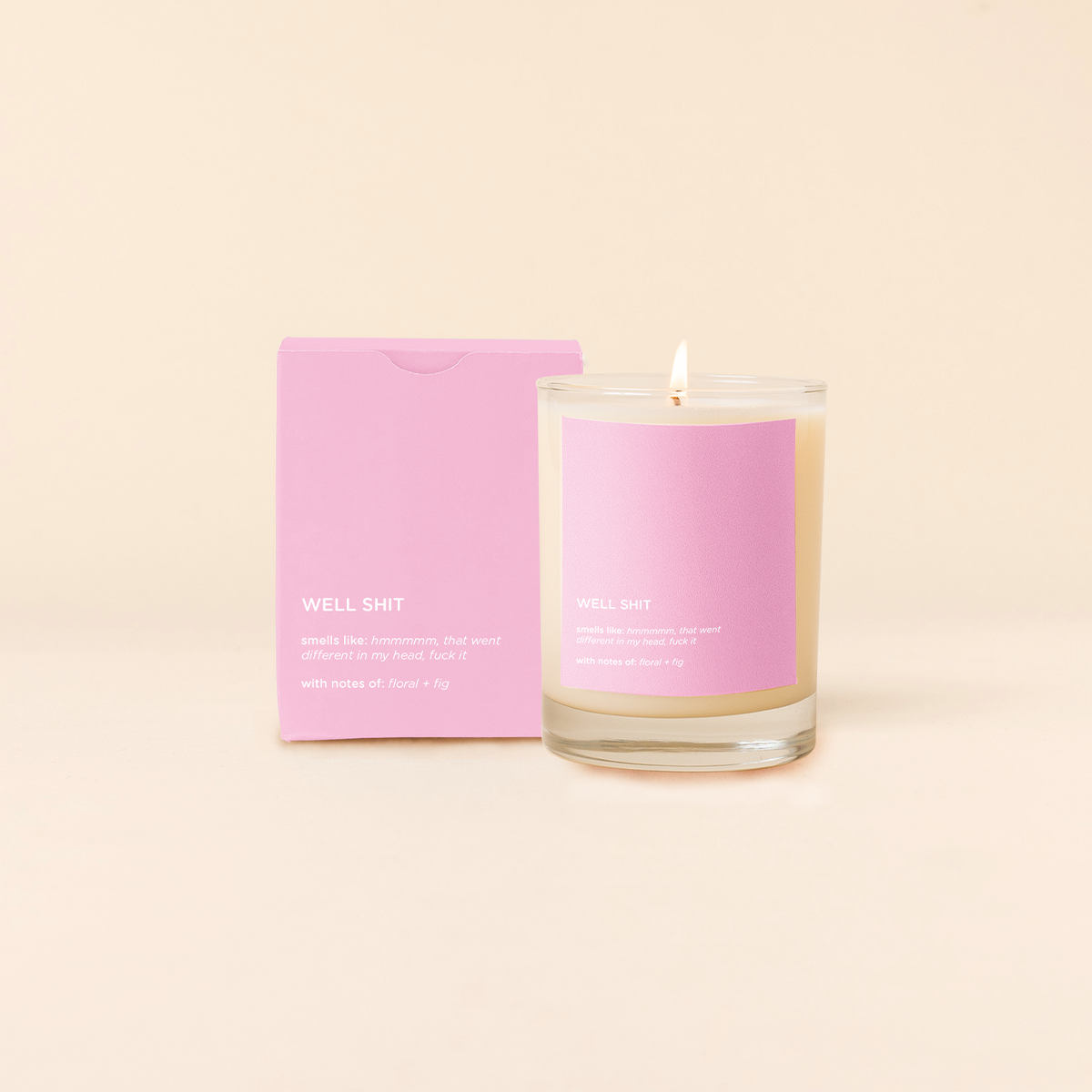 Pink candle and packaging on a beige background