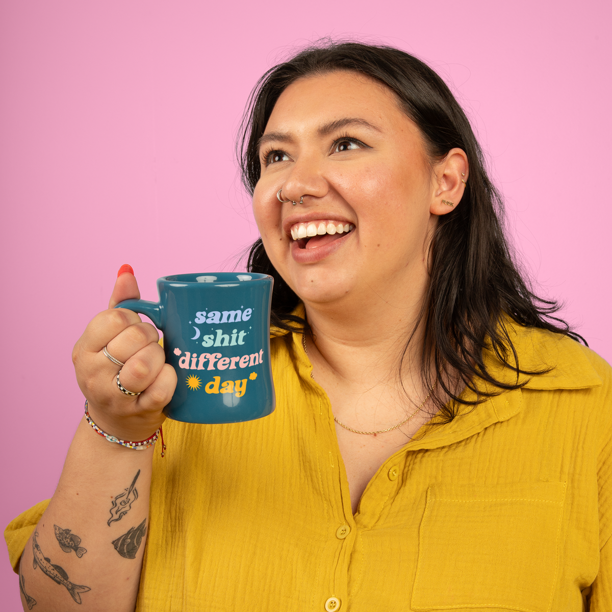 Same sh** different day mug Person holding a blue mug with text against a pink background