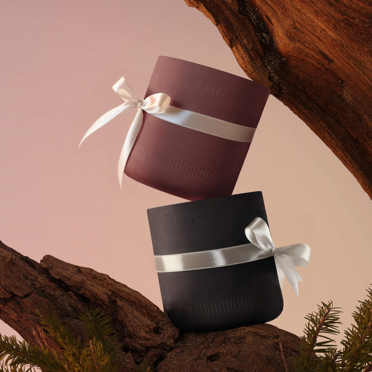 Two cylindrical containers with ribbons stacked on a natural background