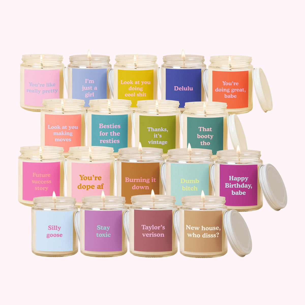 Collection of candles with various text labels on a white background