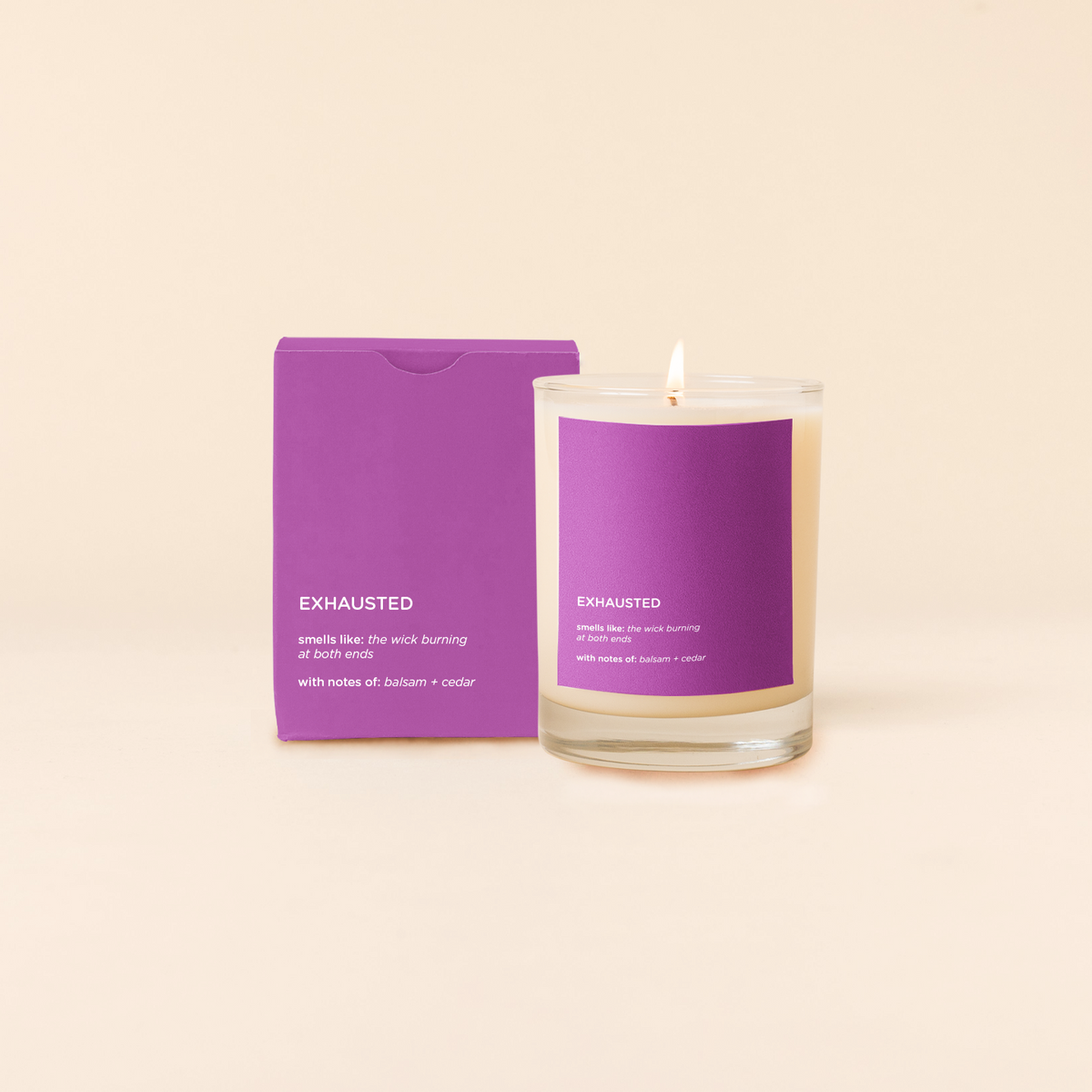 Candle with purple packaging labeled 'Exhausted' on a beige background