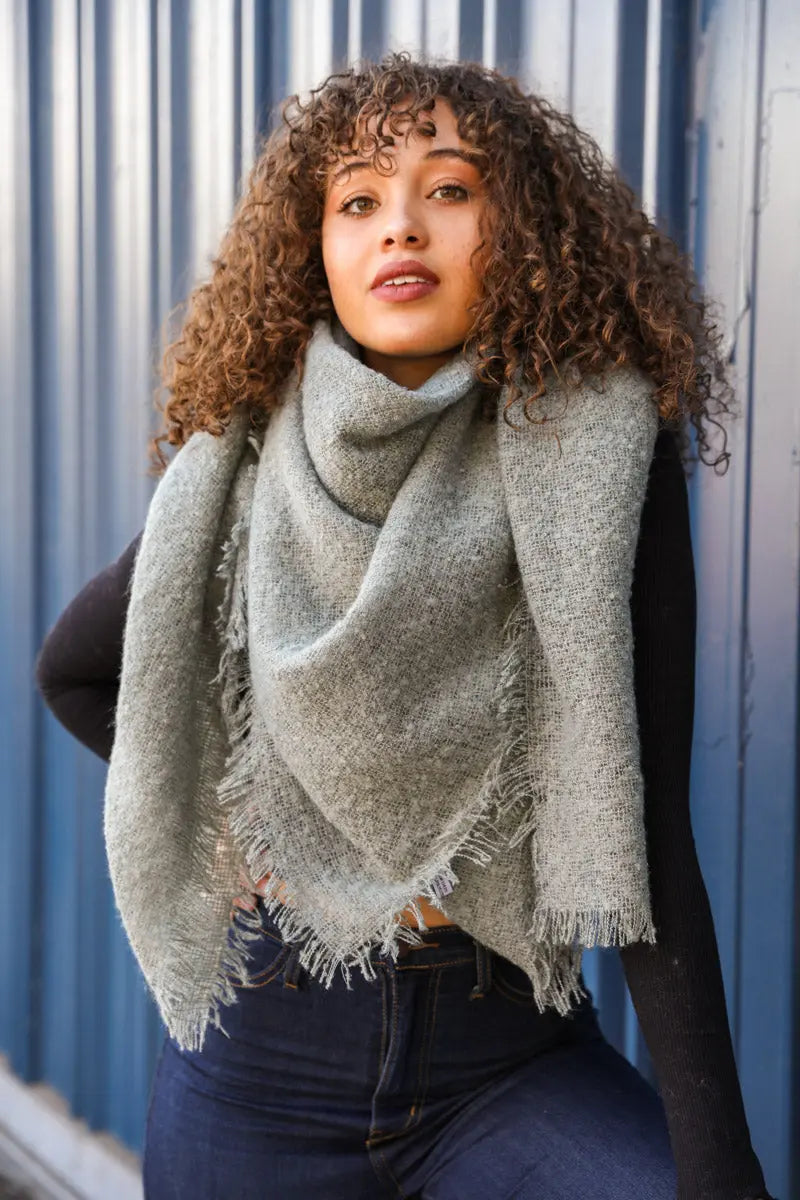 Leto Collection mohair square scarf in sage green with soft, textured fabric and fringed edges, styled as a fashionable accessory.