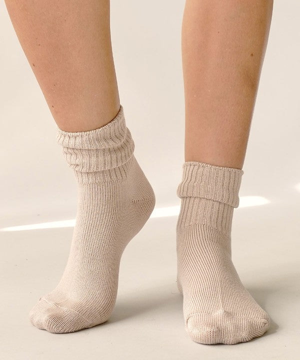 One size organic bamboo socks in neutral colors: grey, olive, taupe, and white, folded and displayed on soft surface.