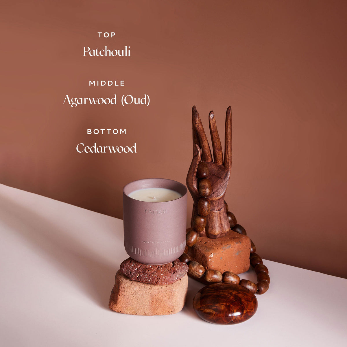 Candle with wooden sculpture on a neutral background