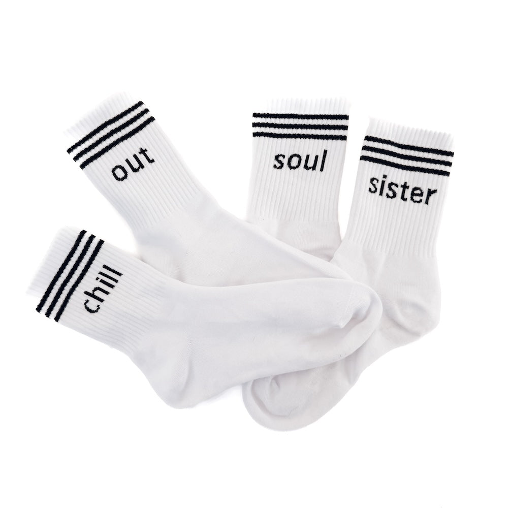 Four white socks with black text and stripes on a white background