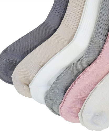 One size organic bamboo socks in neutral colors: grey, olive, taupe, and white, folded and displayed on soft surface.
