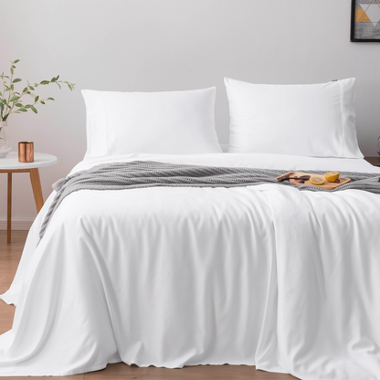 White bedspread with two pillows on a bed in a room setting. Luxurious Organic Bamboo Duvet Cover Set