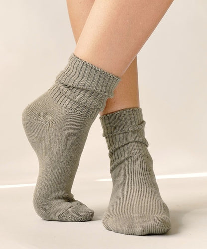 One size organic bamboo socks in neutral colors: grey, olive, taupe, and white, folded and displayed on soft surface.