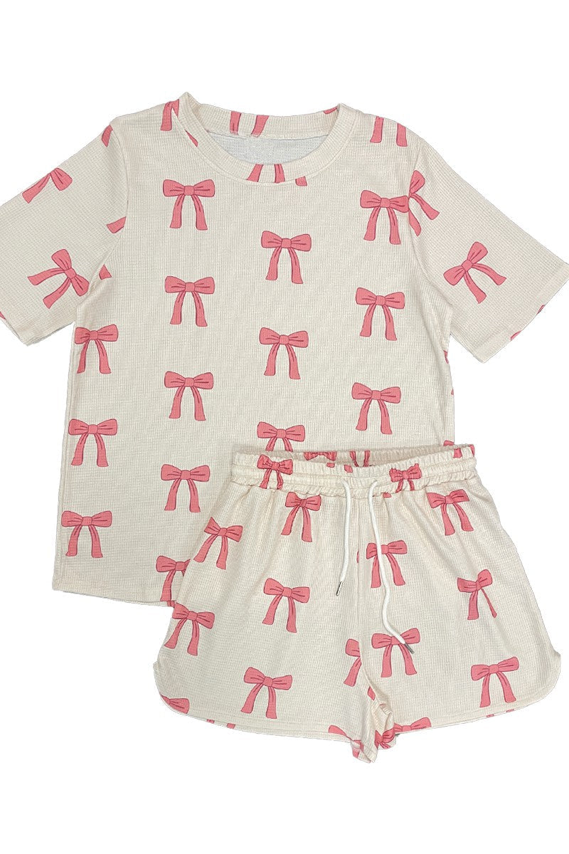 Womens outfit with pink bow pattern on a white background
