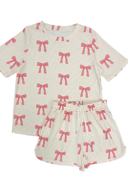Womens outfit with pink bow pattern on a white background