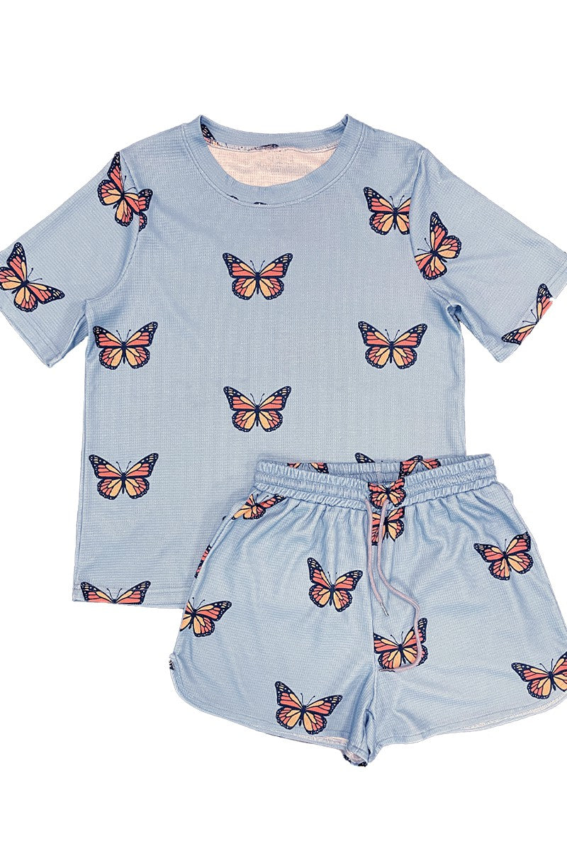 Light blue pajama set with butterfly patterns on a white background