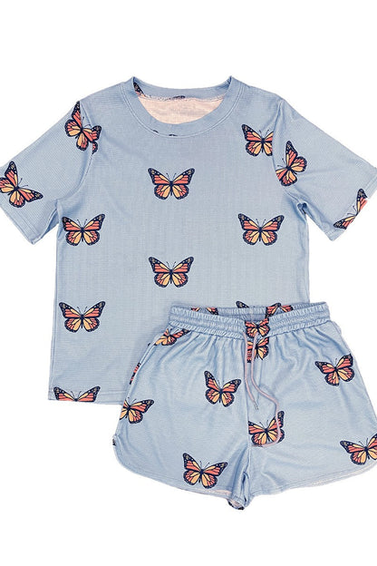 Light blue pajama set with butterfly patterns on a white background
