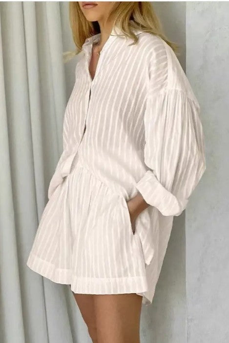 woman wearing cream color two piece set ; a Collared long sleeve shirt with striped pattern - Matching shorts with relaxed fit two-piece design for endless styling options