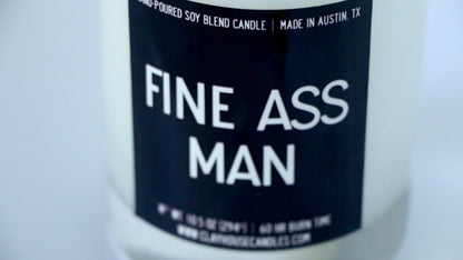 Candle with a label reading 'FINE ASS MAN' on a white background
