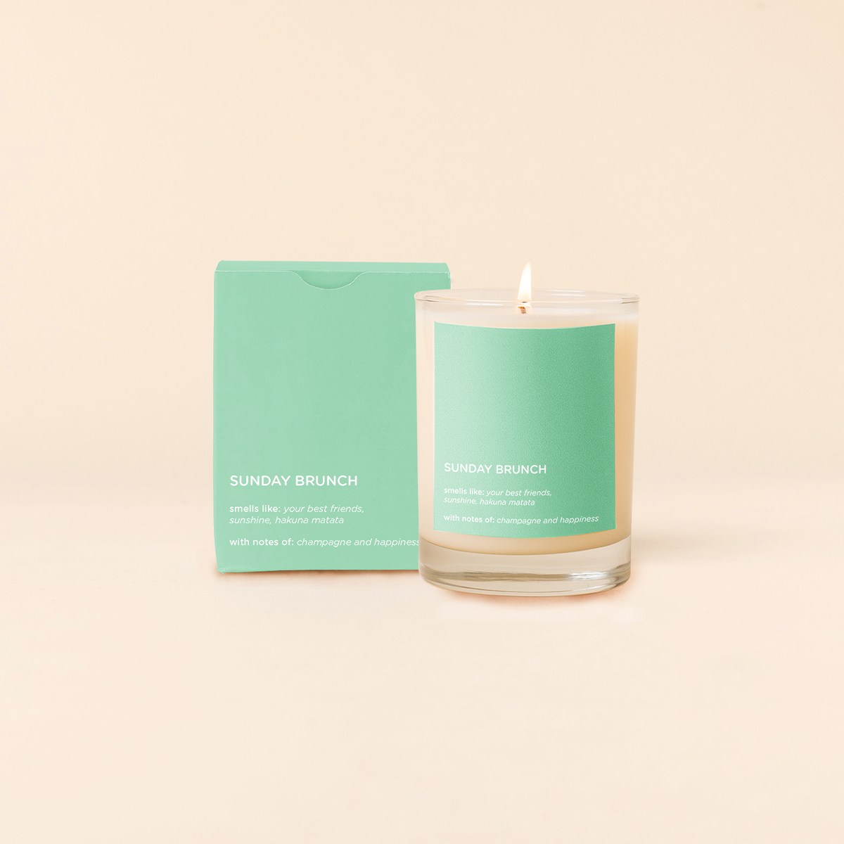 Sunday Brunch Candle with green label and packaging on a beige background