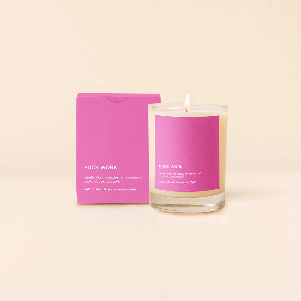 Candle with pink packaging and label on a beige background