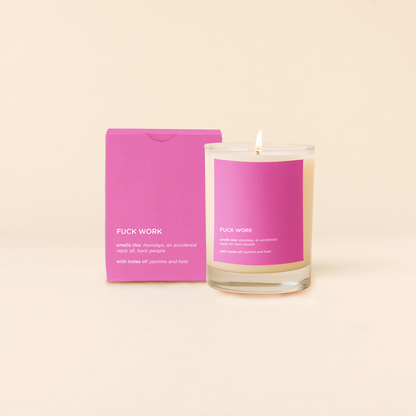 Candle with pink packaging and label on a beige background