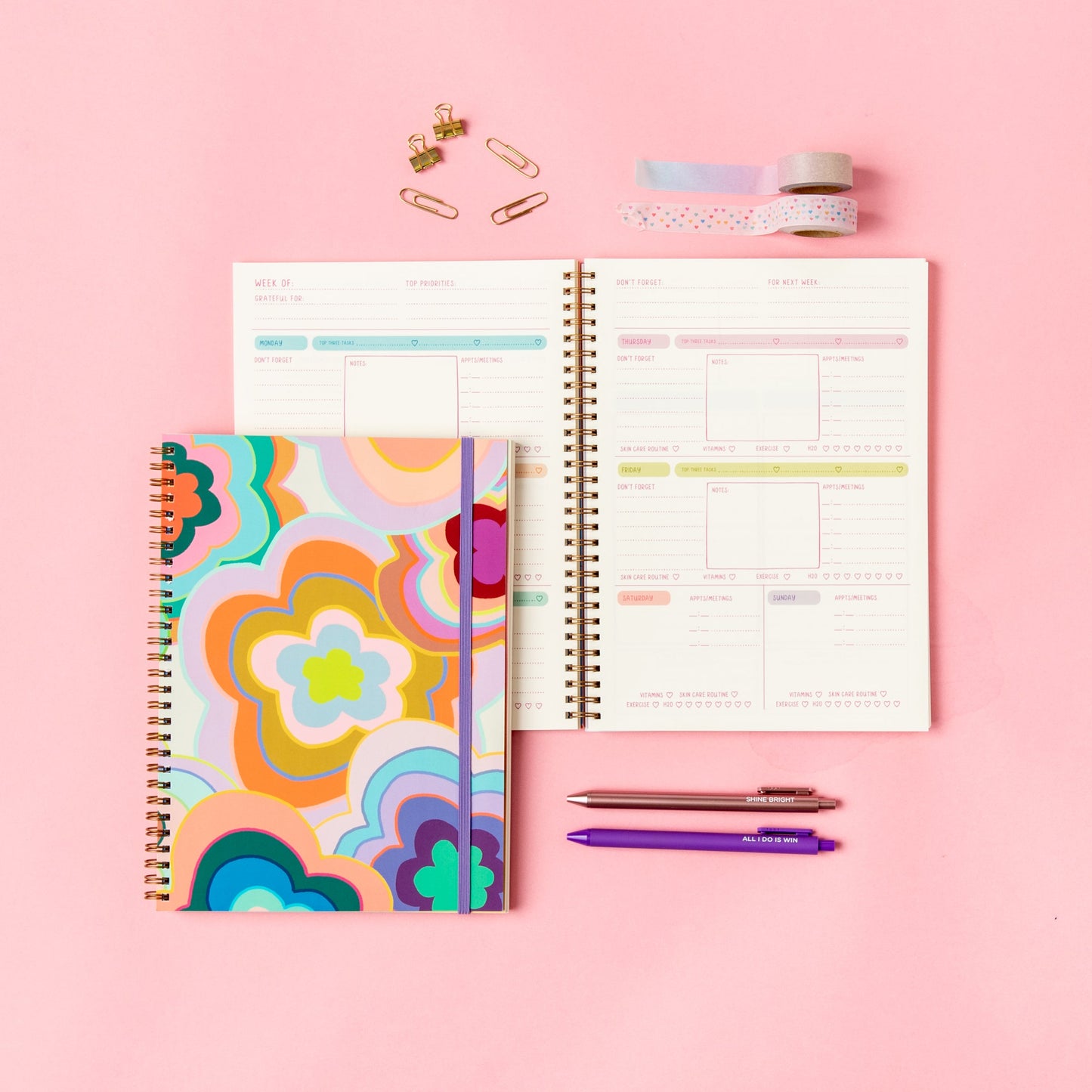 Colorful planner with a floral cover on a pink background