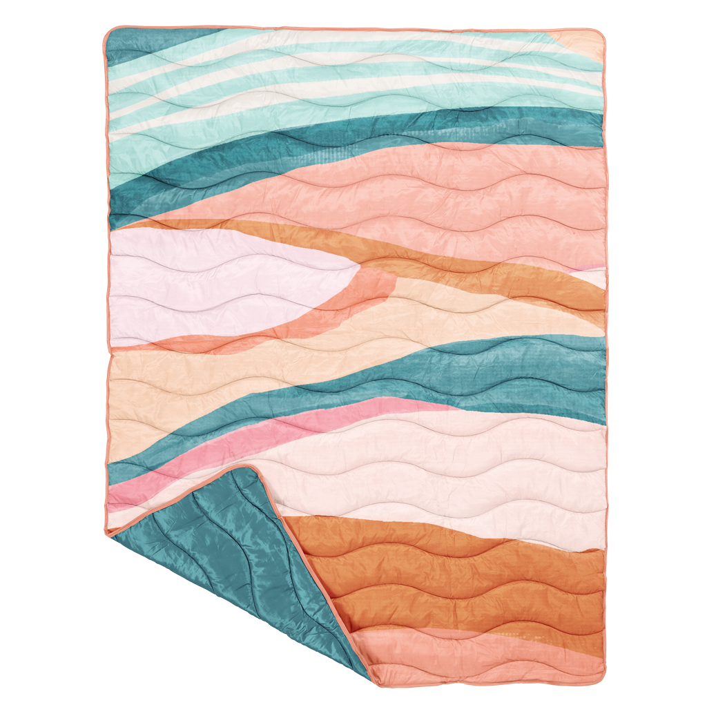 Colorful puffy blanket  with wavy pattern on a white background