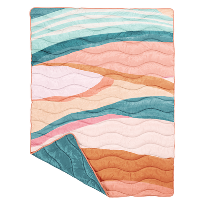 Colorful puffy blanket  with wavy pattern on a white background