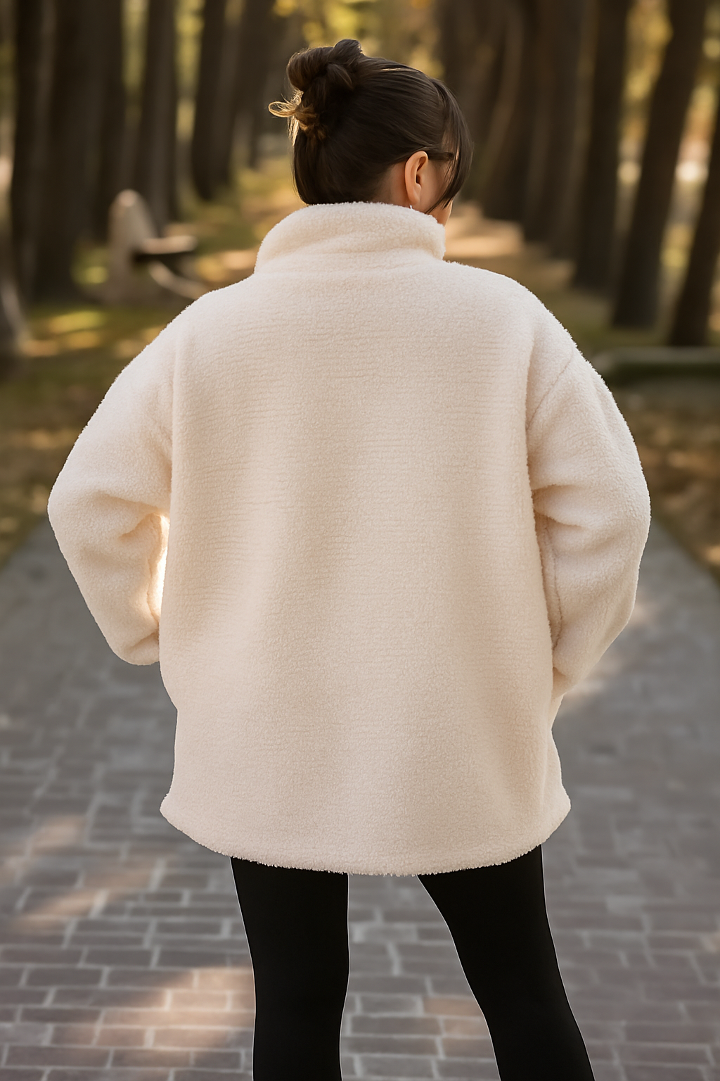 Person wearing a white coat walking away in a forest