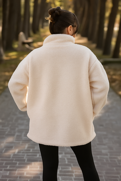 Person wearing a white coat walking away in a forest