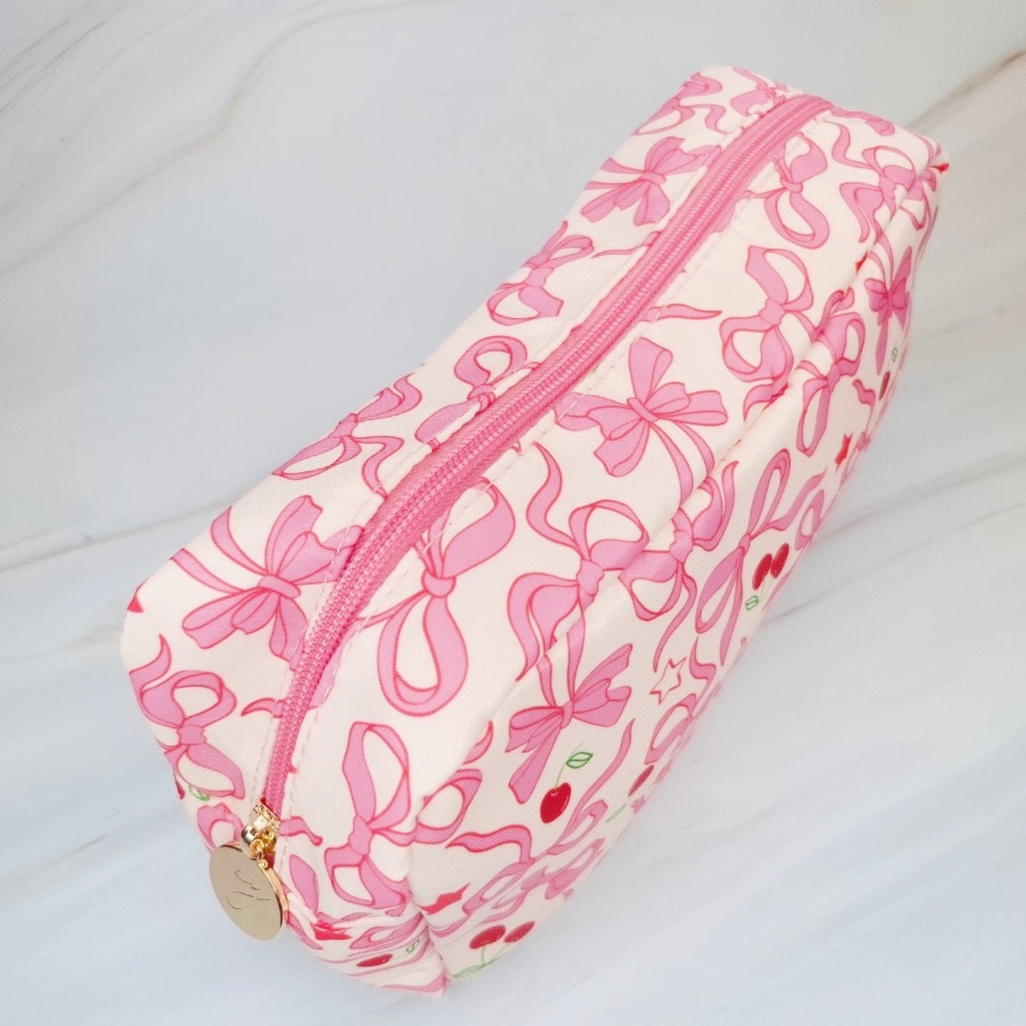 Pencil case with pink bow pattern on a white background