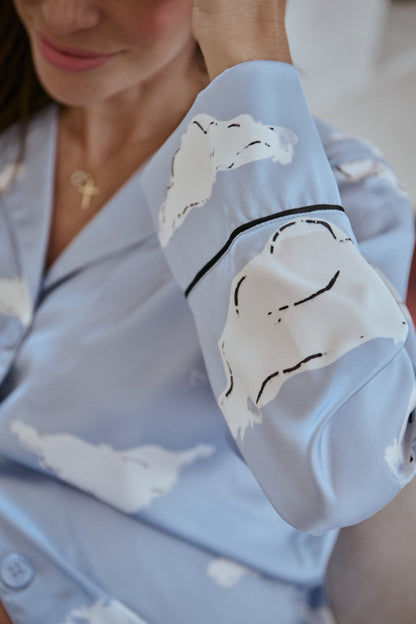 Light blue pajama top with cloud pattern on a blurred background