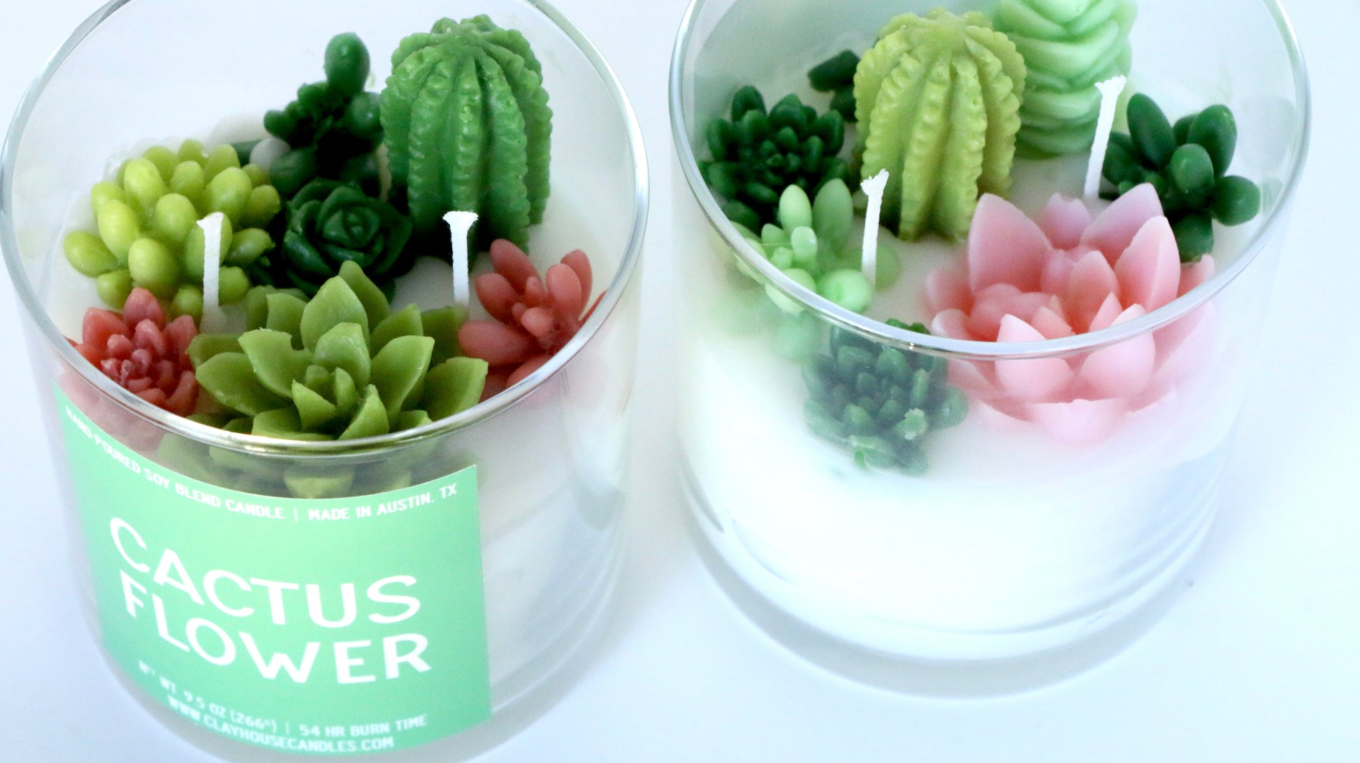 Two candle jars with cactus-shaped candles inside, labeled 'Cactus Flower'.
