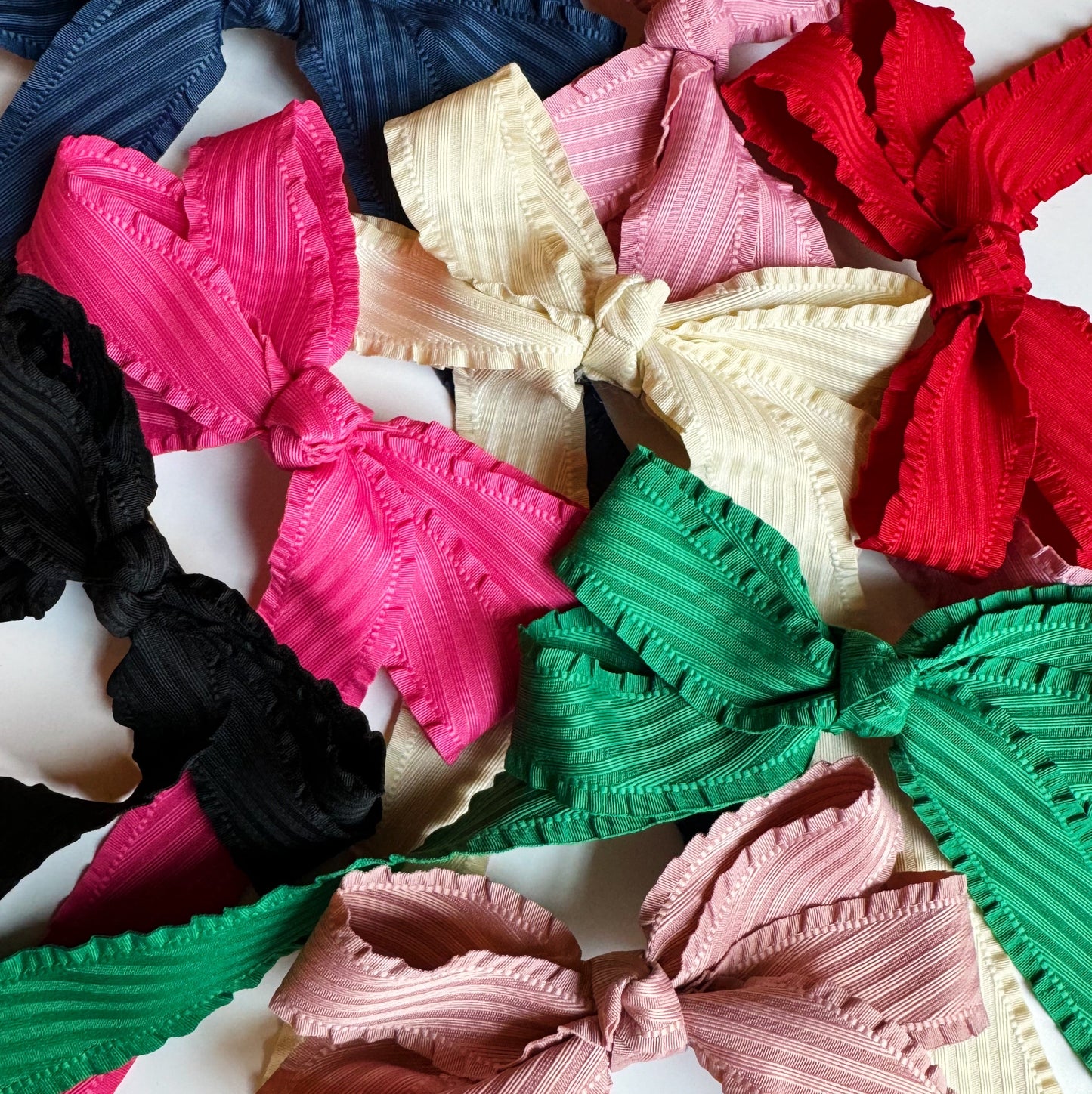 Colorful hair bows in various sizes on a white background