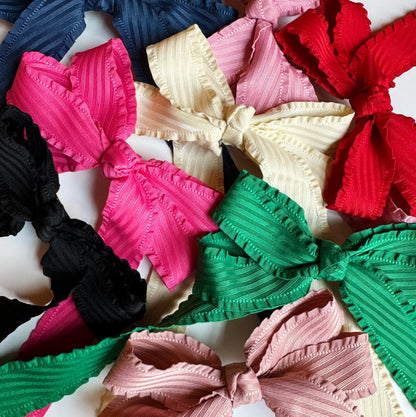 Colorful hair bows in various sizes on a white background
