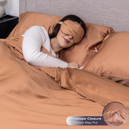 Woman sleeping under brown bedding with an eye mask, surrounded by brown pillows. Luxurious Organic Bamboo Duvet Cover Set