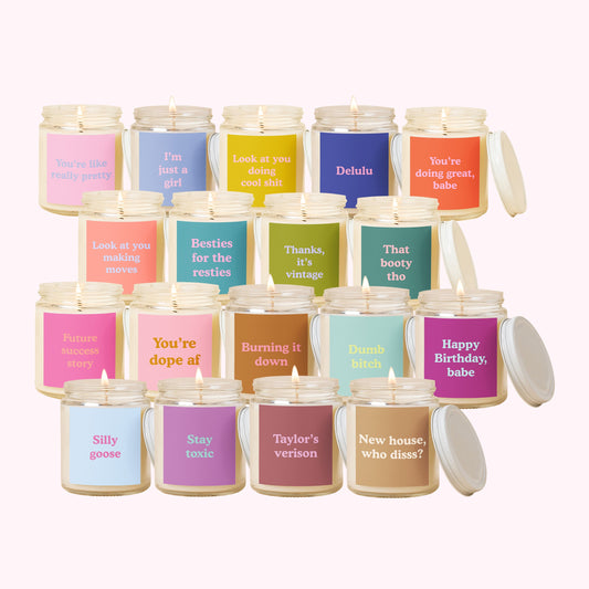 Collection of candles with various text labels on a white background