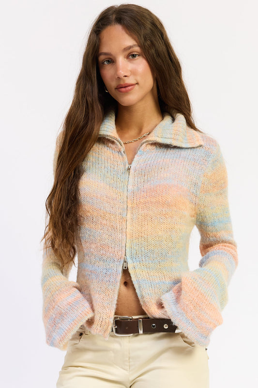 Woman wearing a colorful knitted cardigan on a white background