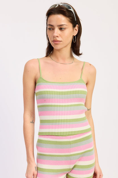 Woman wearing a colorful striped dress on a white background