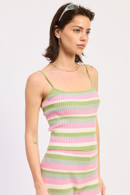Woman wearing a colorful striped dress on a white background