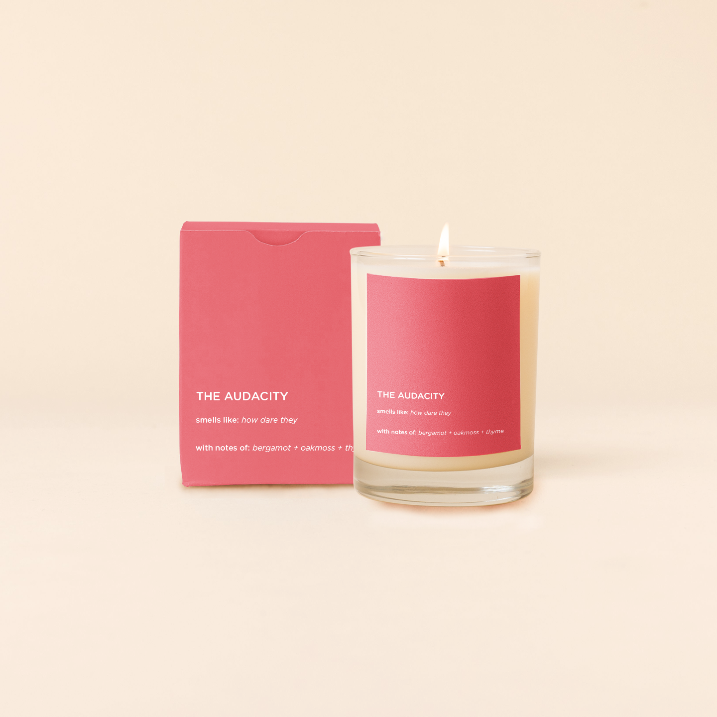 Audacity Candle with pink label and packaging on a beige background