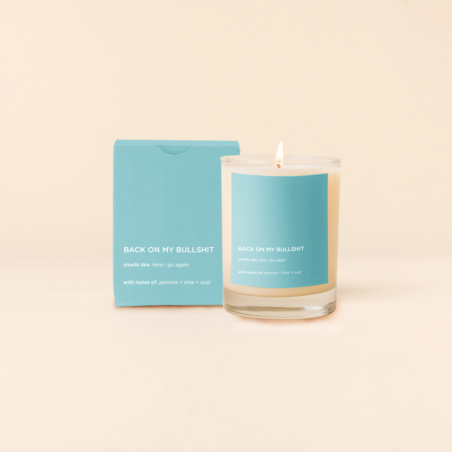 Candle with blue label and packaging on a beige background