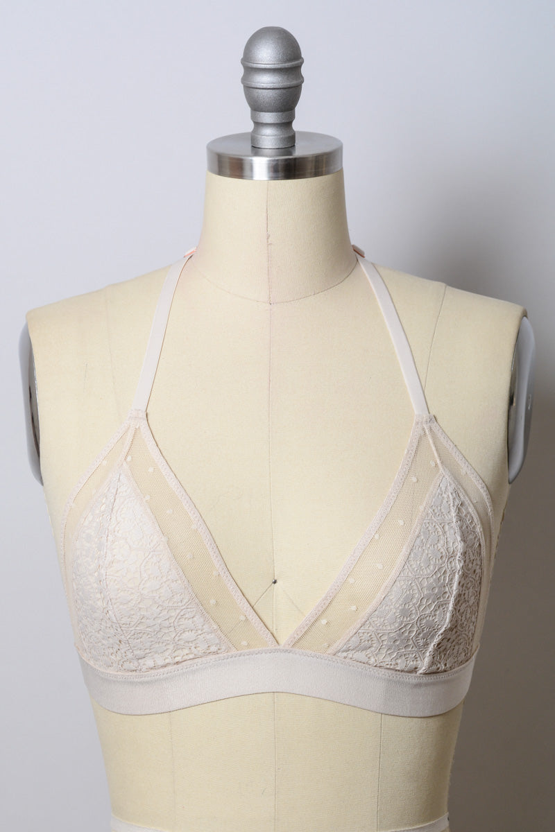 Crochet T-back bralette from Leto Collection featuring natural-colored, intricate crochet design and adjustable straps.