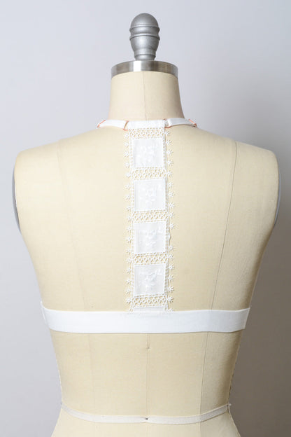 White crochet T-back bralette from Leto Collection with intricate lace detailing and comfortable fit.