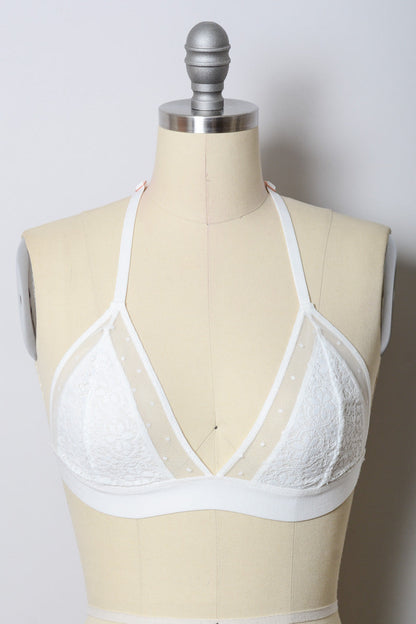 White crochet T-back bralette by Leto Collection featuring intricate crochet design and adjustable straps.