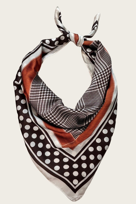 Patterned scarf with polka dots and checkered design on a white background