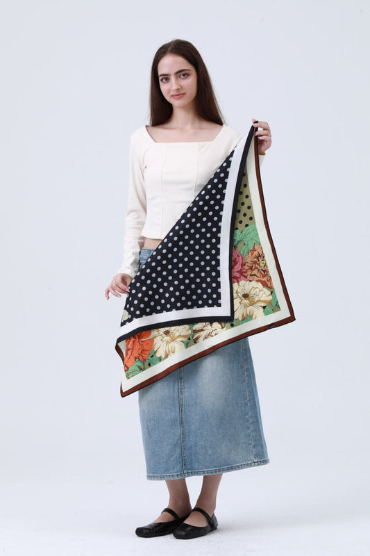 Woman holding a large scarf  with various patterns floral polka dots on a white background