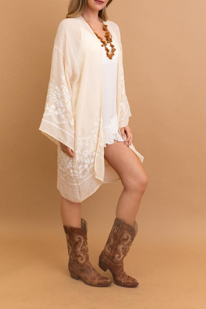 Elegant Blossom Breeze cream kimono with intricate embroidery.