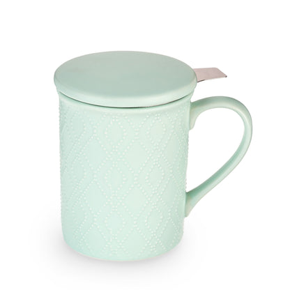 Mint green tea infuser mug with textured design and lid on a white background