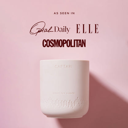 White ceramic cup with 'CAFFARI' branding on a pink background, featuring magazine titles.