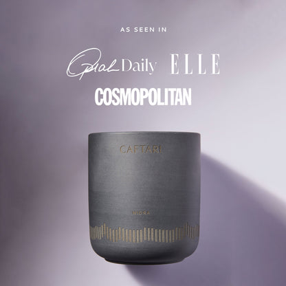 Gray candle with 'Caftari' branding on a purple background, featuring magazine titles.