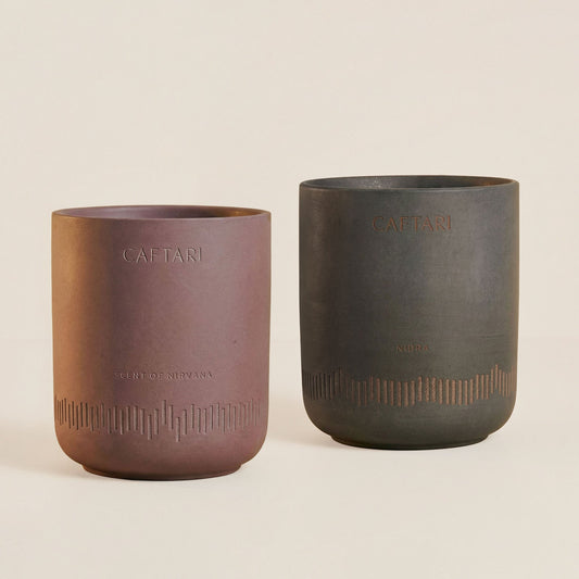 Two ceramic cups with 'CAETArI' branding on a beige background
