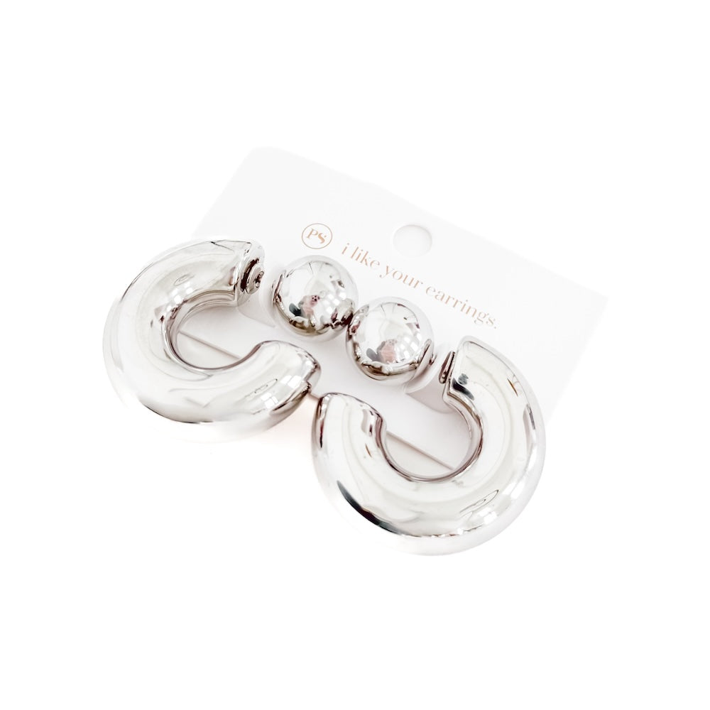 Silver earrings on a white background