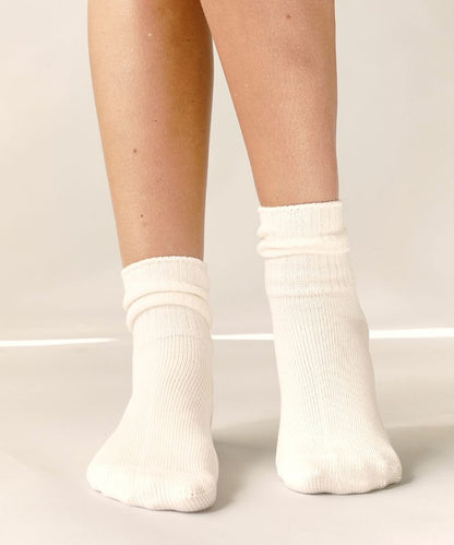 One size organic bamboo socks in neutral colors: grey, olive, taupe, and white, folded and displayed on soft surface.